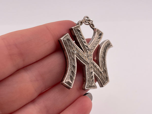 sterling silver large pressed 'NY' New York pendant