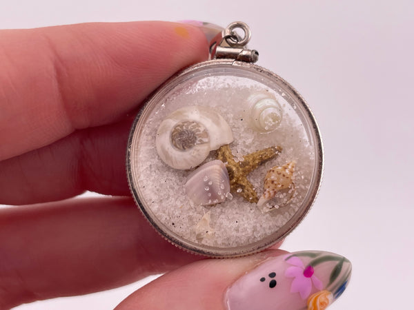 sterling silver sand filled plastic tiny seashells starfish pendant