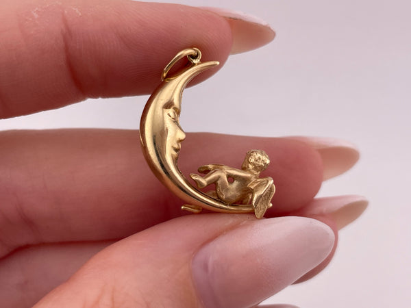 14k yellow gold 3D angel sitting on crescent moon pendant