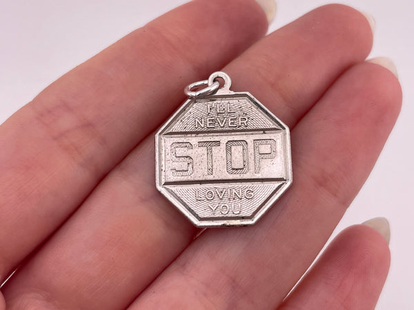 sterling silver rhodium plated "I'll Never Stop Loving You" stop sign pendant