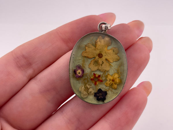 sterling silver flowers in resin pendant