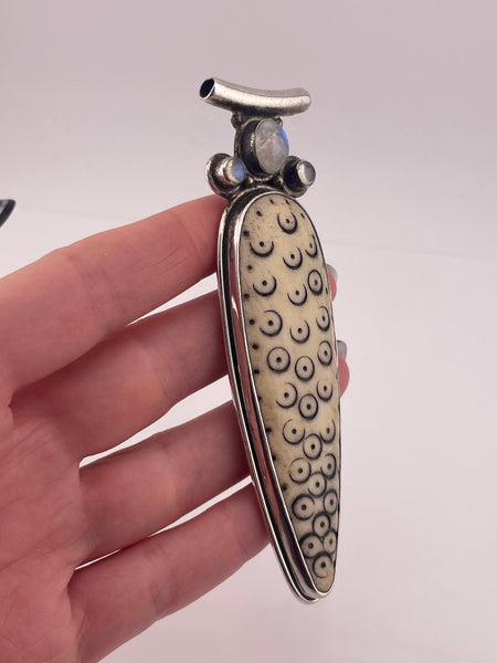 sterling silver 4-1/8" carved antler ? rainbow moonstone pendant