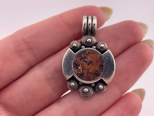 sterling silver bird on tree limb carved material pendant