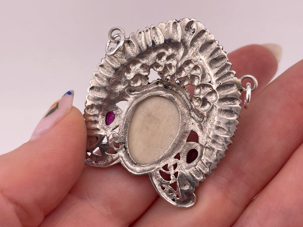 sterling silver faceted lab ruby molded plastic face pendant ***Chipped***