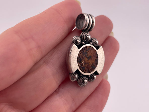 sterling silver bird on tree limb carved material pendant