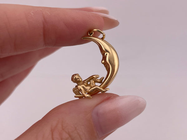 14k yellow gold 3D angel sitting on crescent moon pendant