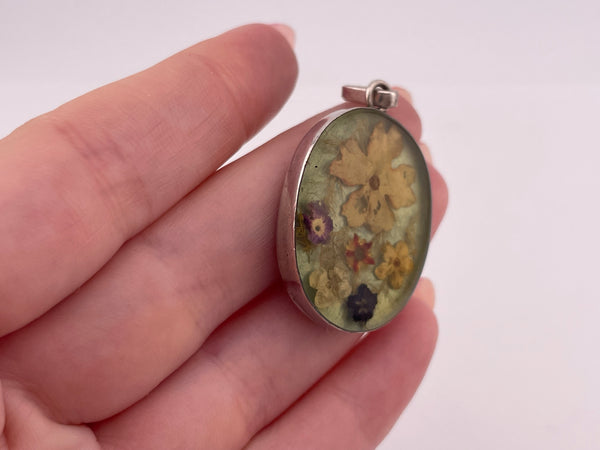 sterling silver flowers in resin pendant